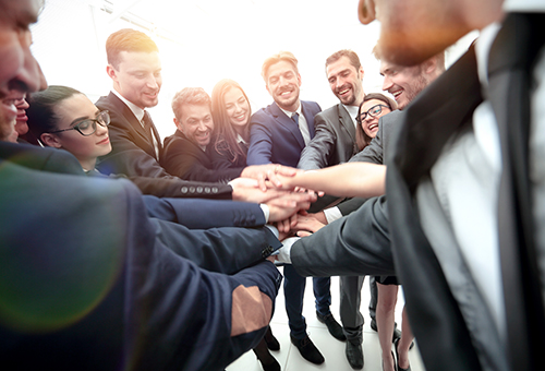 Large,Business,Team,Showing,Unity,With,Their,Hands,Together