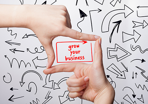 Technology,,Internet,,Business,And,Marketing.,Young,Business,Woman,Writing,Word: There are many ways to reach new heights and develop your business to achieve better results. Learn five tips to effectively expand your business in 2023.
