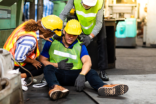 First,Aid.,Engineering,Supervisor,Talking,On,Walkie,Talkie,Communication,While First Aid. Engineering supervisor talking on walkie talkie communication while his coworker lying unconscious at industrial factory. Professional engineering teamwork concept.